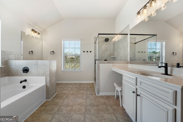 full bathroom featuring baseboards, vaulted ceiling, vanity, a shower stall, and a bath