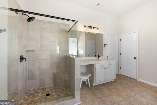 bathroom with baseboards, visible vents, vanity, and a shower stall