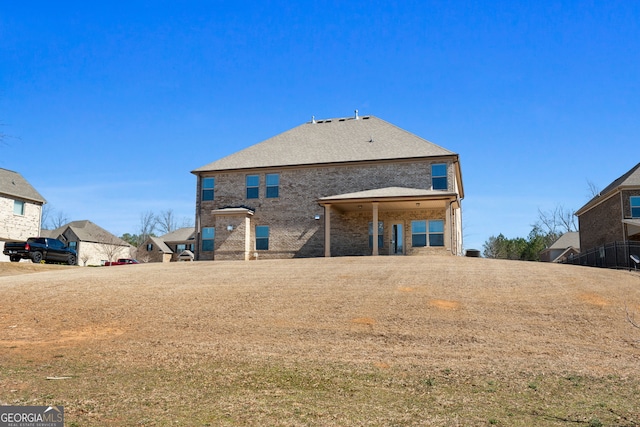 rear view of property featuring brick siding