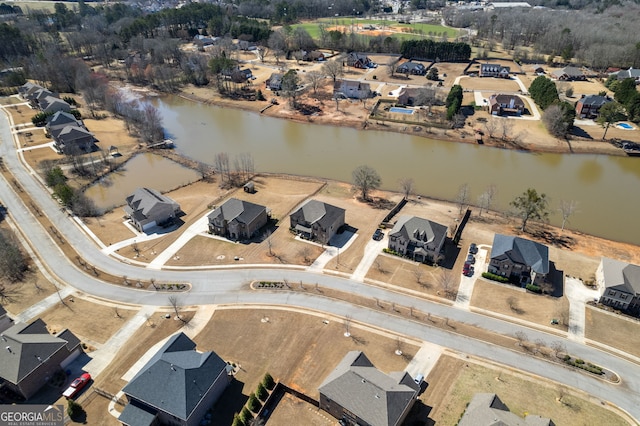 drone / aerial view featuring a water view and a residential view