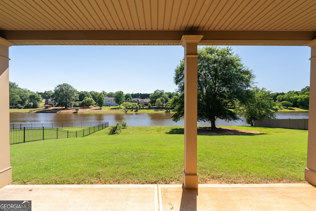 view of yard featuring a water view and fence