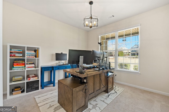 office space with baseboards, an inviting chandelier, visible vents, and light colored carpet