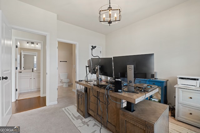 office space with light carpet, baseboards, and an inviting chandelier