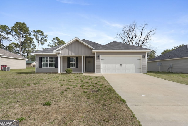 single story home featuring an attached garage, driveway, board and batten siding, and a front yard