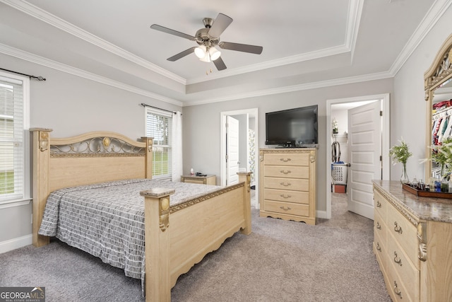 bedroom featuring baseboards, a tray ceiling, and light colored carpet