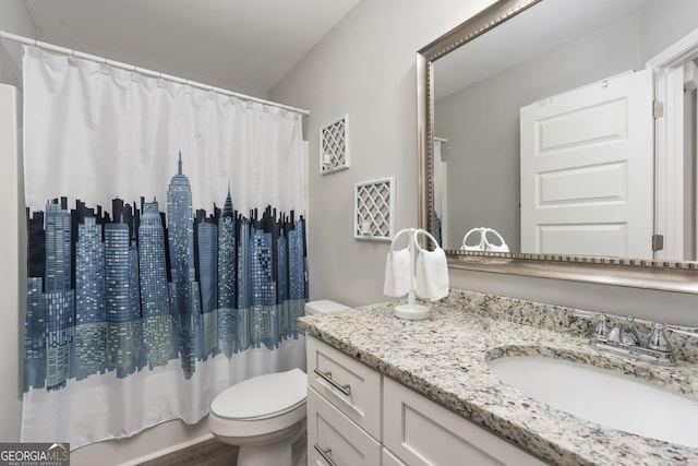 bathroom with shower / tub combo, vanity, and toilet