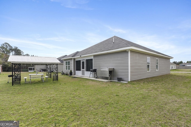 back of house with a yard and a patio