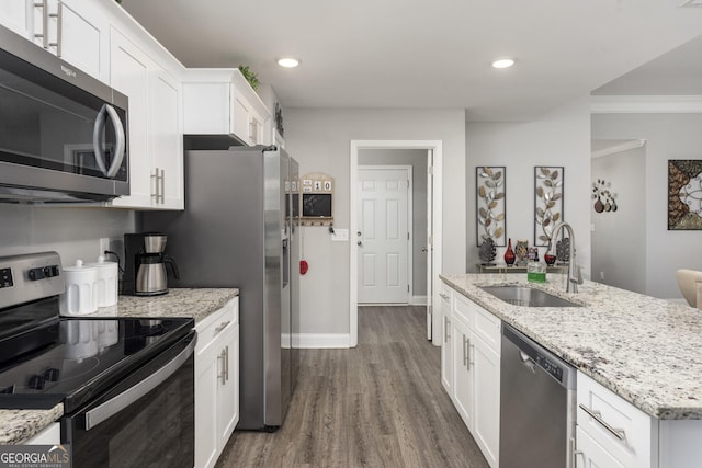 kitchen featuring a sink, white cabinetry, appliances with stainless steel finishes, light stone countertops, and dark wood-style floors