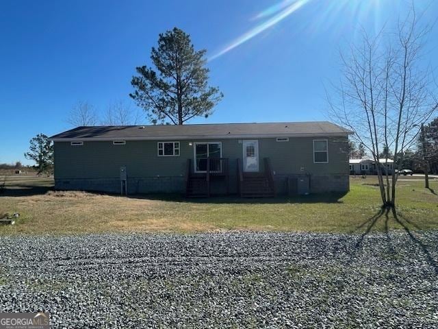 view of front of home featuring entry steps, crawl space, and a front lawn