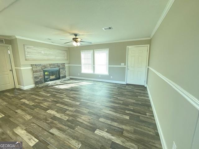 unfurnished living room featuring crown molding, dark wood finished floors, visible vents, and a fireplace