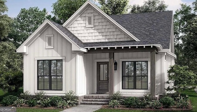 modern farmhouse featuring roof with shingles and board and batten siding