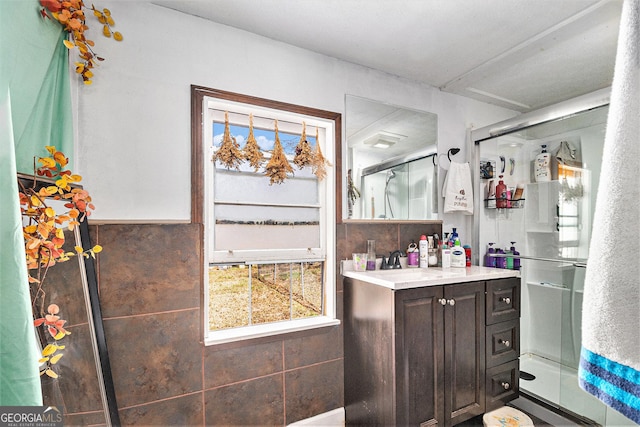 full bath featuring vanity and an enclosed shower