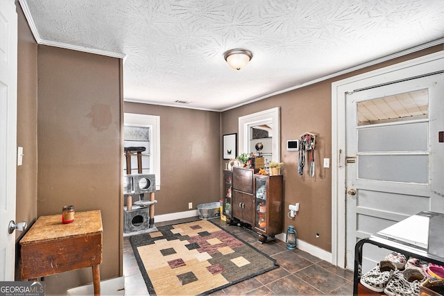 interior space featuring a textured ceiling and baseboards