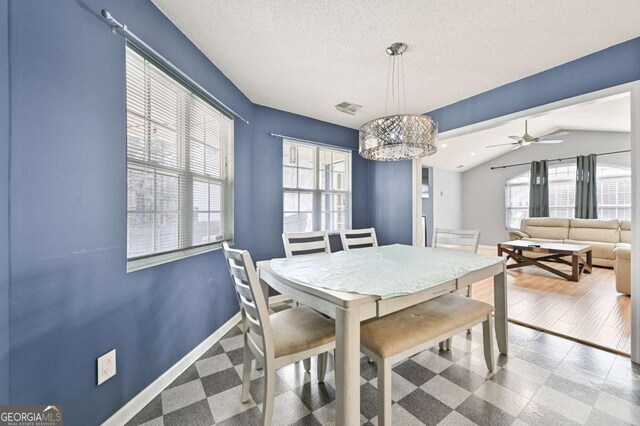 dining area featuring vaulted ceiling, baseboards, visible vents, and a healthy amount of sunlight