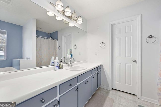 bathroom with visible vents, vanity, and baseboards