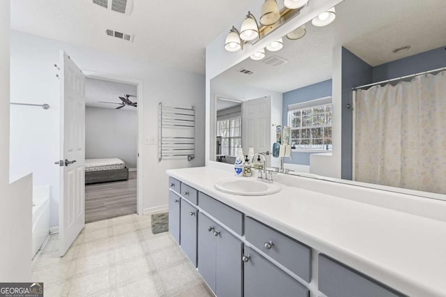 ensuite bathroom featuring visible vents, ensuite bathroom, vanity, baseboards, and tile patterned floors