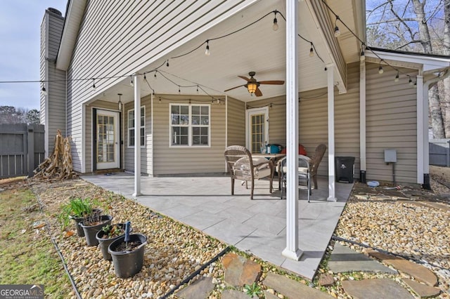 view of patio with fence and a ceiling fan