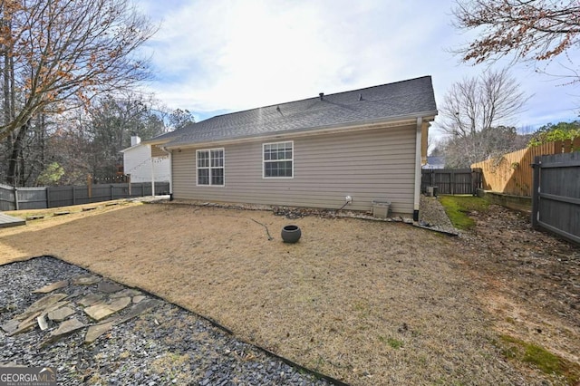 rear view of property with a fenced backyard