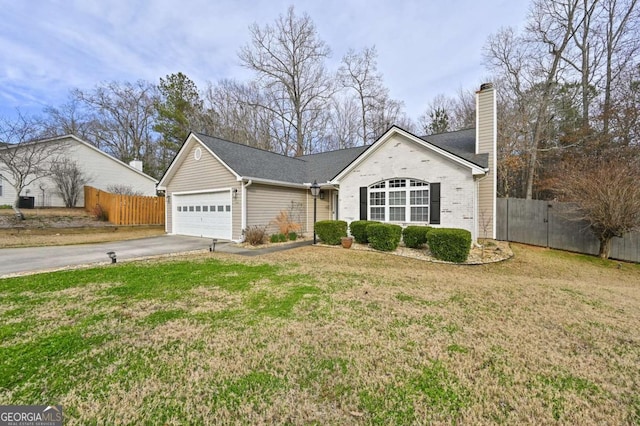 ranch-style home featuring concrete driveway, fence, a chimney, and a front lawn