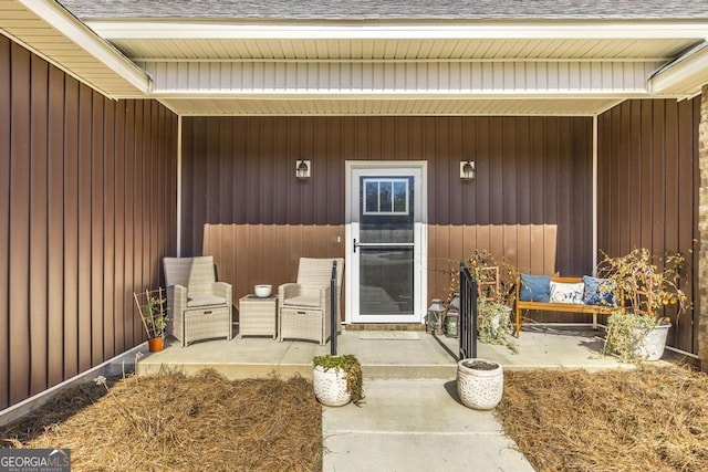 property entrance with a shingled roof