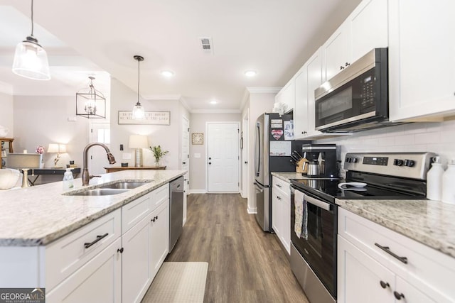 kitchen featuring tasteful backsplash, visible vents, white cabinets, appliances with stainless steel finishes, and a sink