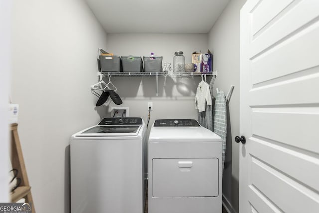 washroom featuring laundry area and washer and clothes dryer