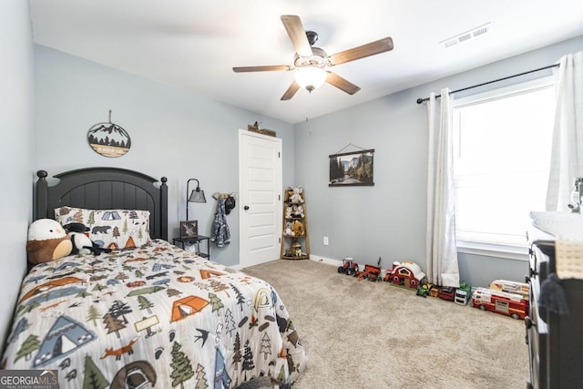 bedroom featuring baseboards, carpet, visible vents, and a ceiling fan