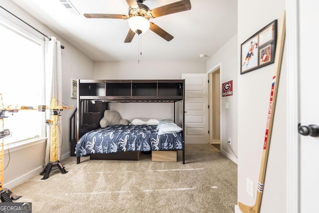 bedroom with a ceiling fan, carpet flooring, and baseboards