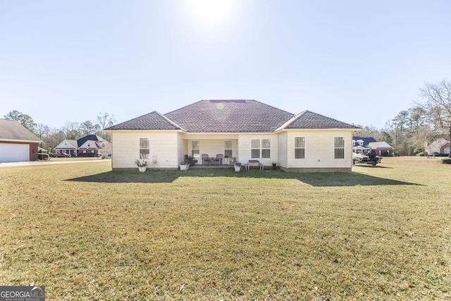 rear view of house with a lawn