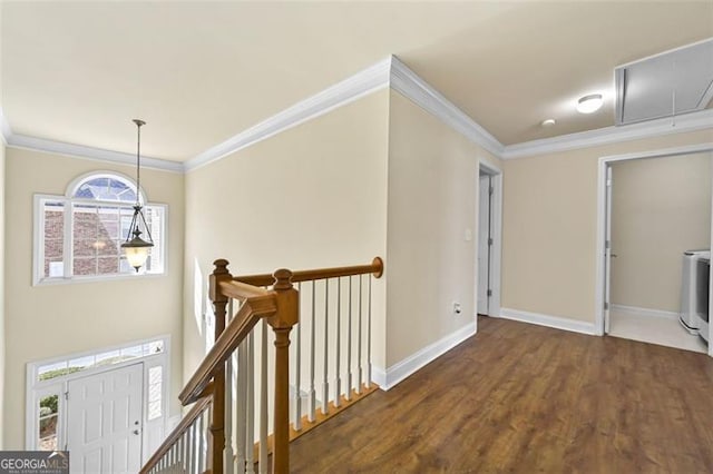 corridor with ornamental molding, dark wood-style flooring, an upstairs landing, and attic access