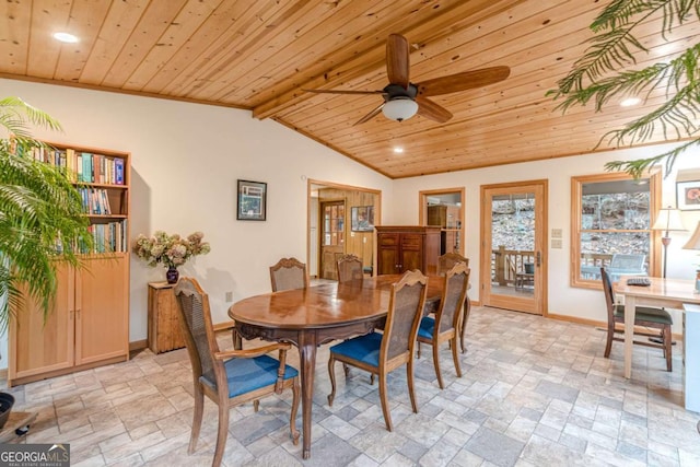 dining room featuring wood ceiling, stone finish flooring, and baseboards