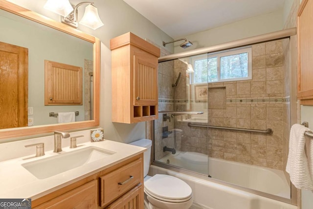 full bathroom with shower / bath combination with glass door, vanity, and toilet