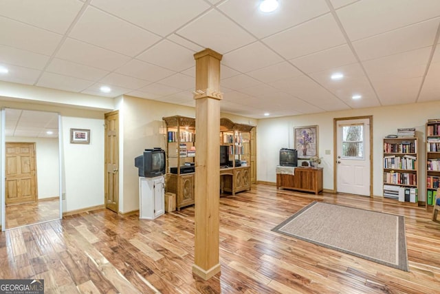 interior space featuring a paneled ceiling, recessed lighting, light wood-style flooring, and baseboards