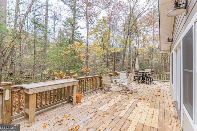 wooden terrace with outdoor dining area