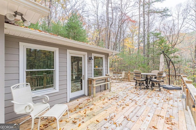 wooden deck featuring outdoor dining area