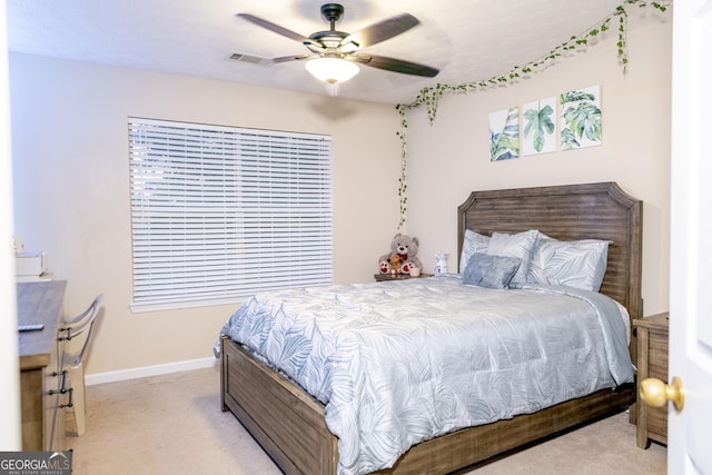 bedroom with baseboards, visible vents, a ceiling fan, and light colored carpet