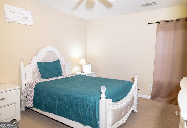 carpeted bedroom with a ceiling fan, visible vents, and baseboards