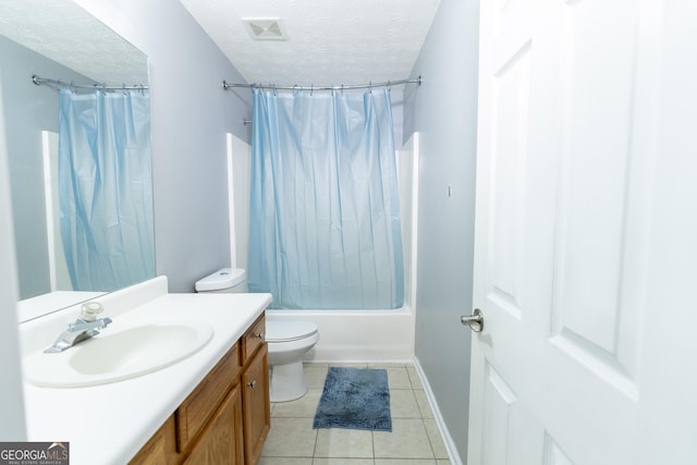 bathroom featuring visible vents, toilet, tile patterned floors, a textured ceiling, and vanity