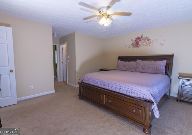 bedroom featuring a textured ceiling, light carpet, a ceiling fan, and baseboards