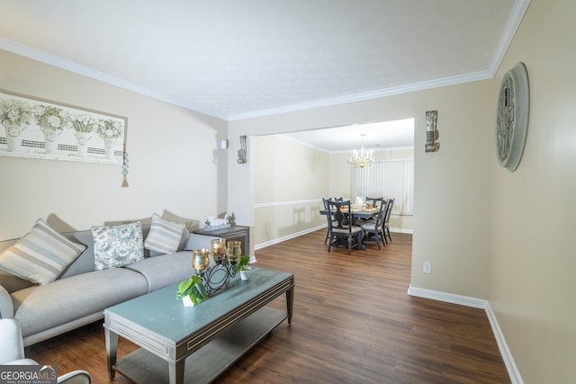 living area with a chandelier, crown molding, baseboards, and wood finished floors