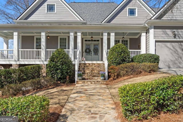 view of front facade featuring covered porch and a shingled roof