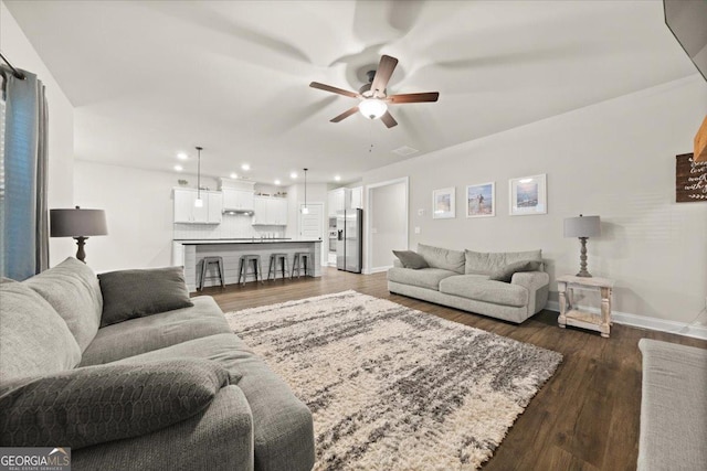 living room featuring recessed lighting, ceiling fan, baseboards, and wood finished floors