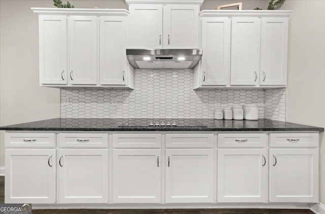 kitchen featuring black electric stovetop, under cabinet range hood, white cabinetry, and backsplash