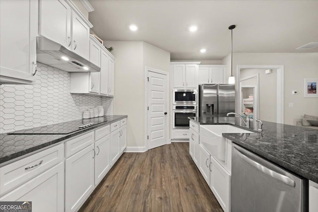 kitchen featuring stainless steel appliances, dark wood finished floors, white cabinetry, and under cabinet range hood