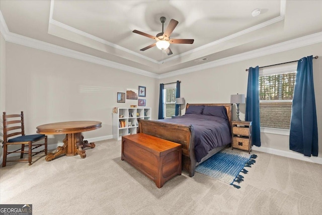 bedroom with carpet floors, a tray ceiling, and visible vents