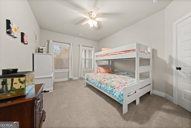 bedroom with light carpet, ceiling fan, visible vents, and baseboards