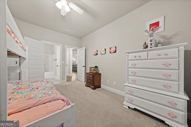 carpeted bedroom with a ceiling fan, visible vents, and baseboards