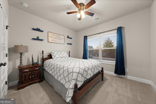 bedroom featuring baseboards, visible vents, ceiling fan, and light colored carpet