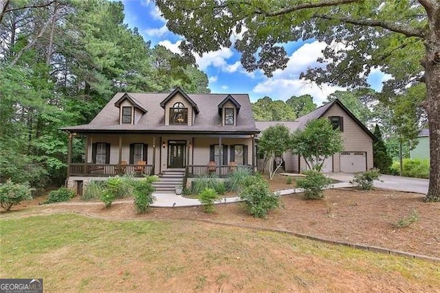 cape cod home with driveway, covered porch, and a front lawn