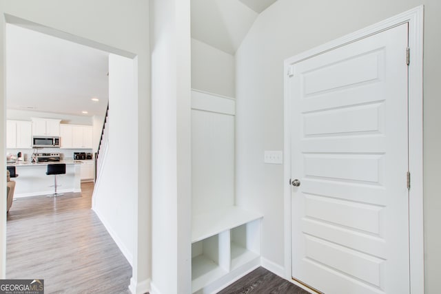 mudroom featuring recessed lighting, light wood-style flooring, and baseboards